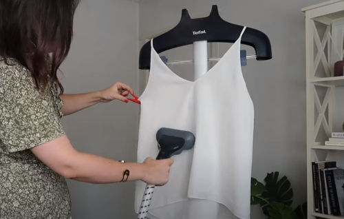 hanging clothes in a padded hanger for steaming