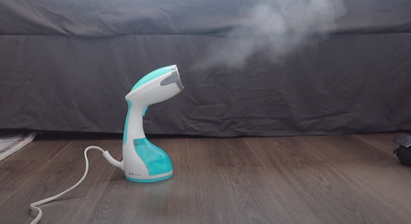 using travel steamer to remove wrinkles